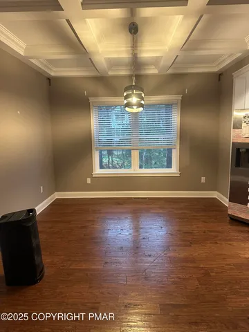a view of a room with wooden floor