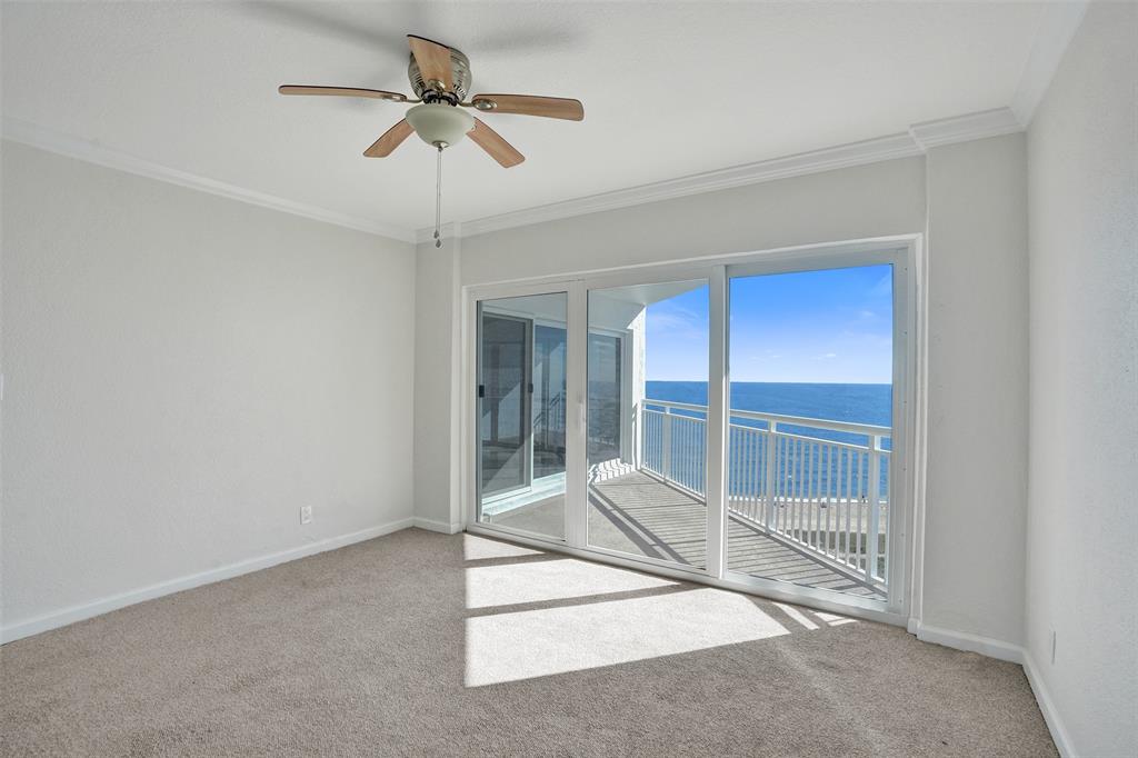 710 North Ocean Boulevard, Unit 910 Pompano Beach, FL 33062 - Photo 15 of 65 a room with sliding glass door