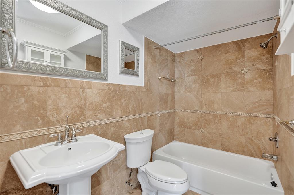 710 North Ocean Boulevard, Unit 910 Pompano Beach, FL 33062 - Photo 19 of 65 a bathroom with a toilet a sink and bathtub
