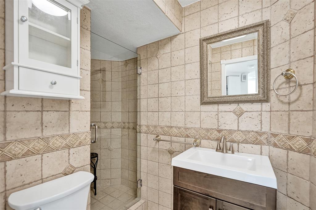 710 North Ocean Boulevard, Unit 910 Pompano Beach, FL 33062 - Photo 23 of 65 a bathroom with a sink toilet and shower