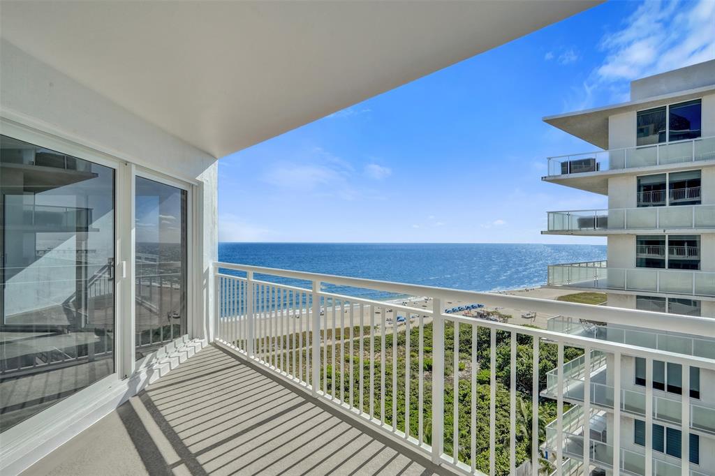 710 North Ocean Boulevard, Unit 910 Pompano Beach, FL 33062 - Photo 65 of 65 a view of a balcony with a floor to ceiling window and wooden floor