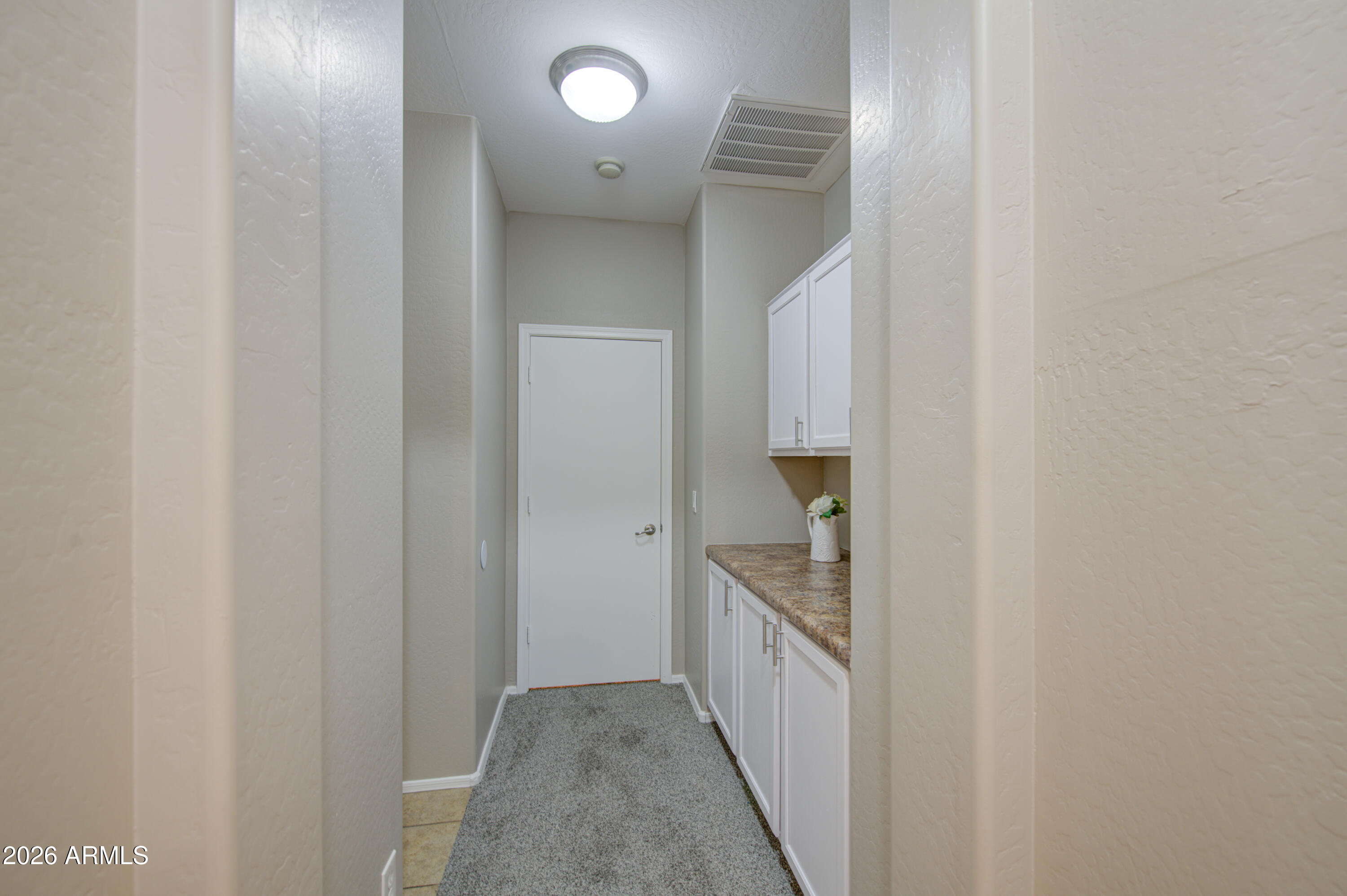 7759 West Monte Vista Road Phoenix, AZ 85035 - Photo 24 of 43 a view of a hallway with wooden shelves