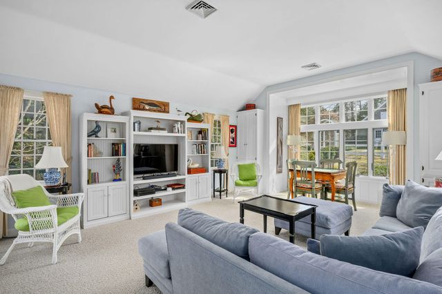 a living room with furniture and large windows