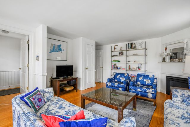 a bedroom with a bed a book shelf and a window