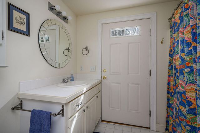 a view of a house with a yard covered with snow