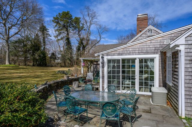 a backyard of a house with outdoor seating