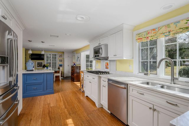 a kitchen with white cabinets and appliances