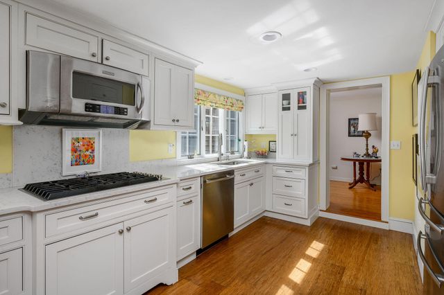 a kitchen with stainless steel appliances granite countertop a stove and refrigerator