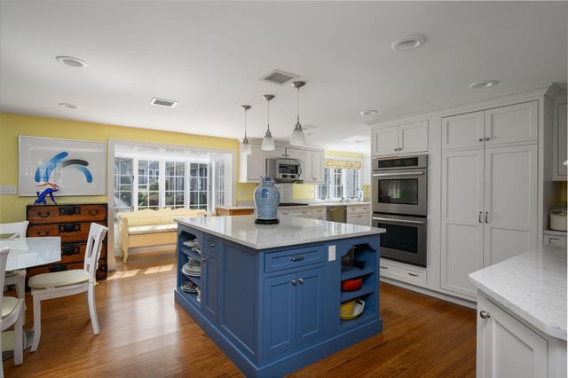 a kitchen with stainless steel appliances granite countertop sink stove top oven and cabinets