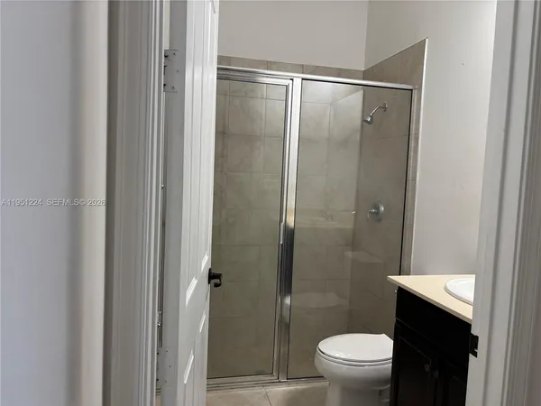 a bathroom with a shower and a toilet