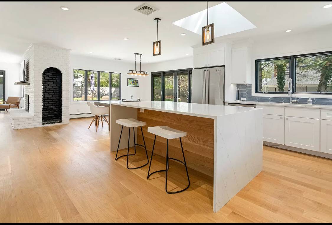 1 High Point Road East Hampton, NY 11937 - Photo 2 of 12 a dining hall with stainless steel appliances granite countertop a stove a refrigerator a sink dishwasher with a dining table and chairs with wooden floor