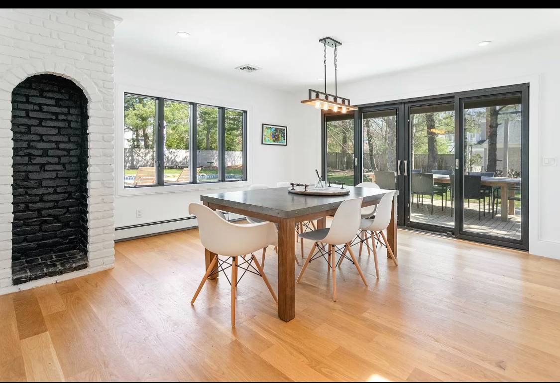 1 High Point Road East Hampton, NY 11937 - Photo 5 of 12 a dining room with wooden floor a chandelier a wooden table and chairs