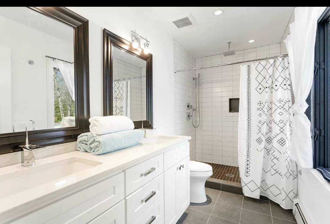 1 High Point Road East Hampton, NY 11937 - Photo 6 of 12 a bathroom with a double vanity sink toilet and shower