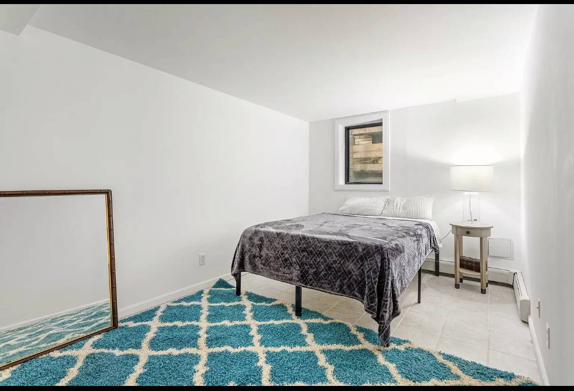 1 High Point Road East Hampton, NY 11937 - Photo 10 of 12 a bedroom with a bed and a mirror