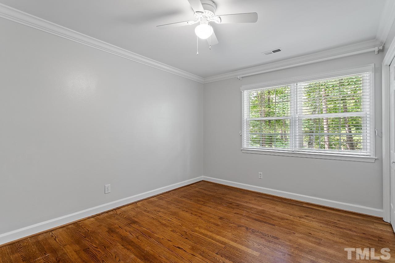 59 Kimberly Drive Durham, NC 27707 - Photo 35 of 68 a view of an empty room with wooden floor and a window