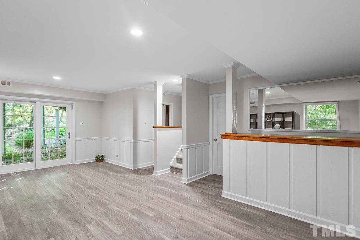 59 Kimberly Drive Durham, NC 27707 - Photo 46 of 68 a view of an empty room with wooden floor and a window