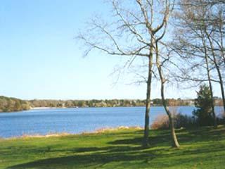 Undisclosed Address Eastham, MA 02642 - Photo 2 of 4 a view of a lake with a yard