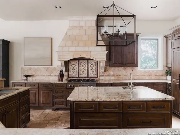 a kitchen with stainless steel appliances granite countertop a sink and stove