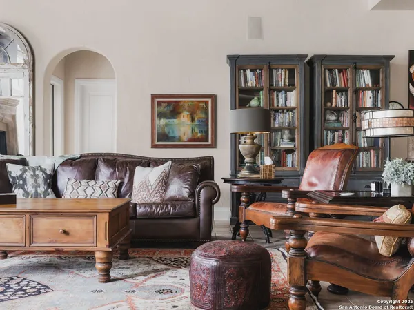 a dining room with furniture a floor to ceiling window and a mirror
