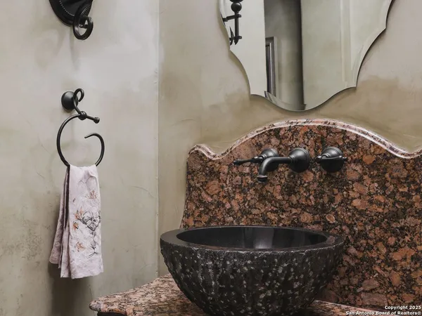 a bathroom with a painting on the wall and a shower