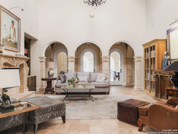 a living room with fireplace furniture and a rug