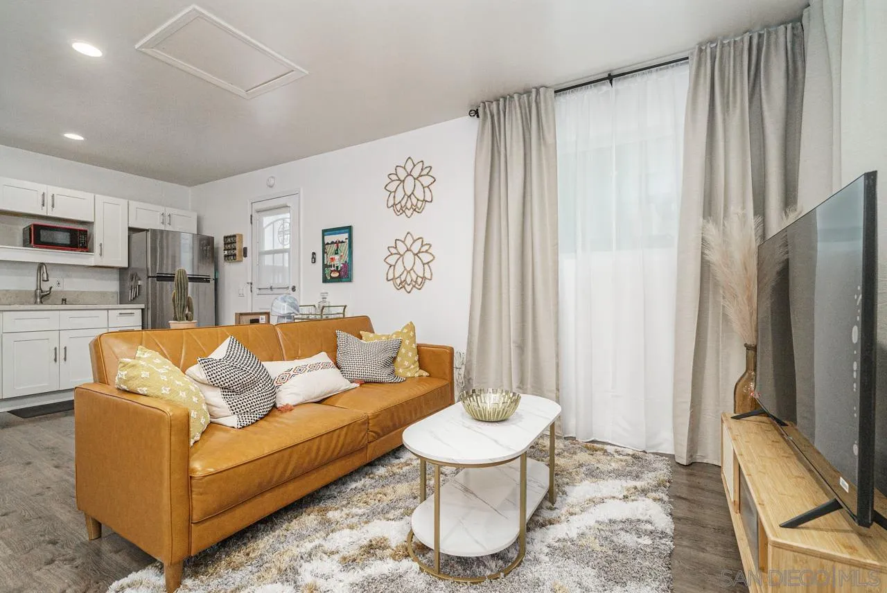 9026 Avocado Street Spring Valley, CA 91977 - Photo 12 of 27 a living room with furniture and a flat screen tv