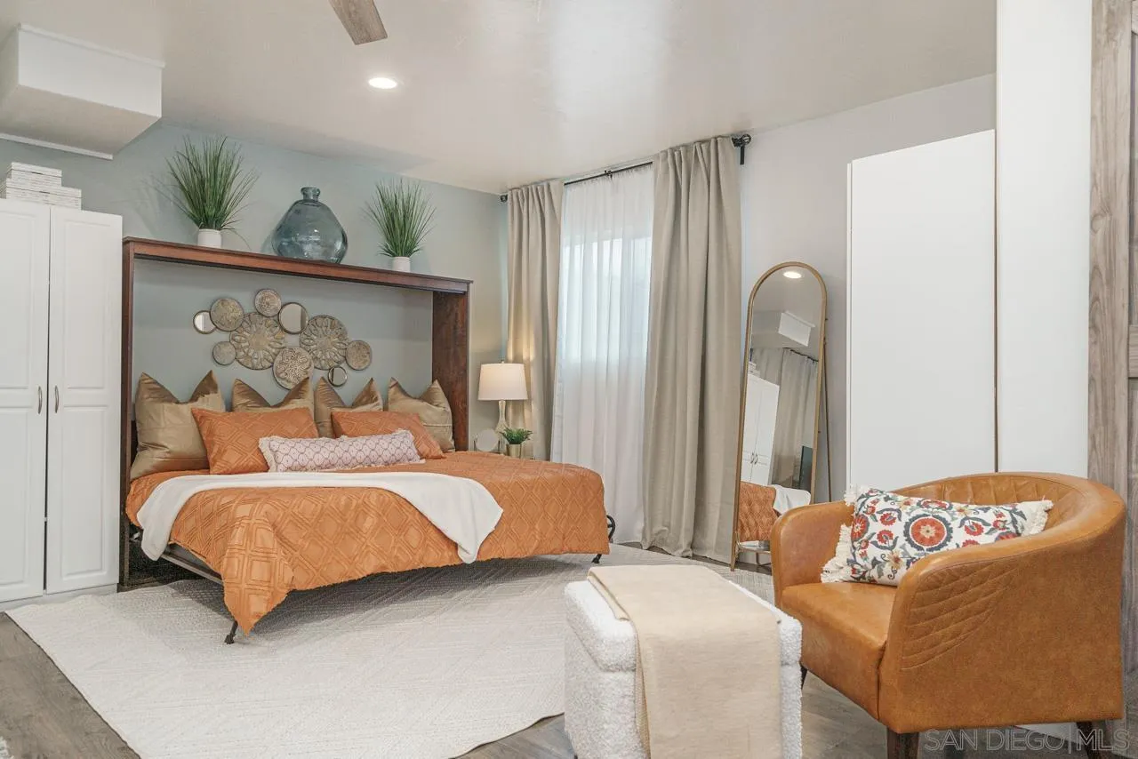 9026 Avocado Street Spring Valley, CA 91977 - Photo 13 of 27 a bedroom with a bed and wooden floor