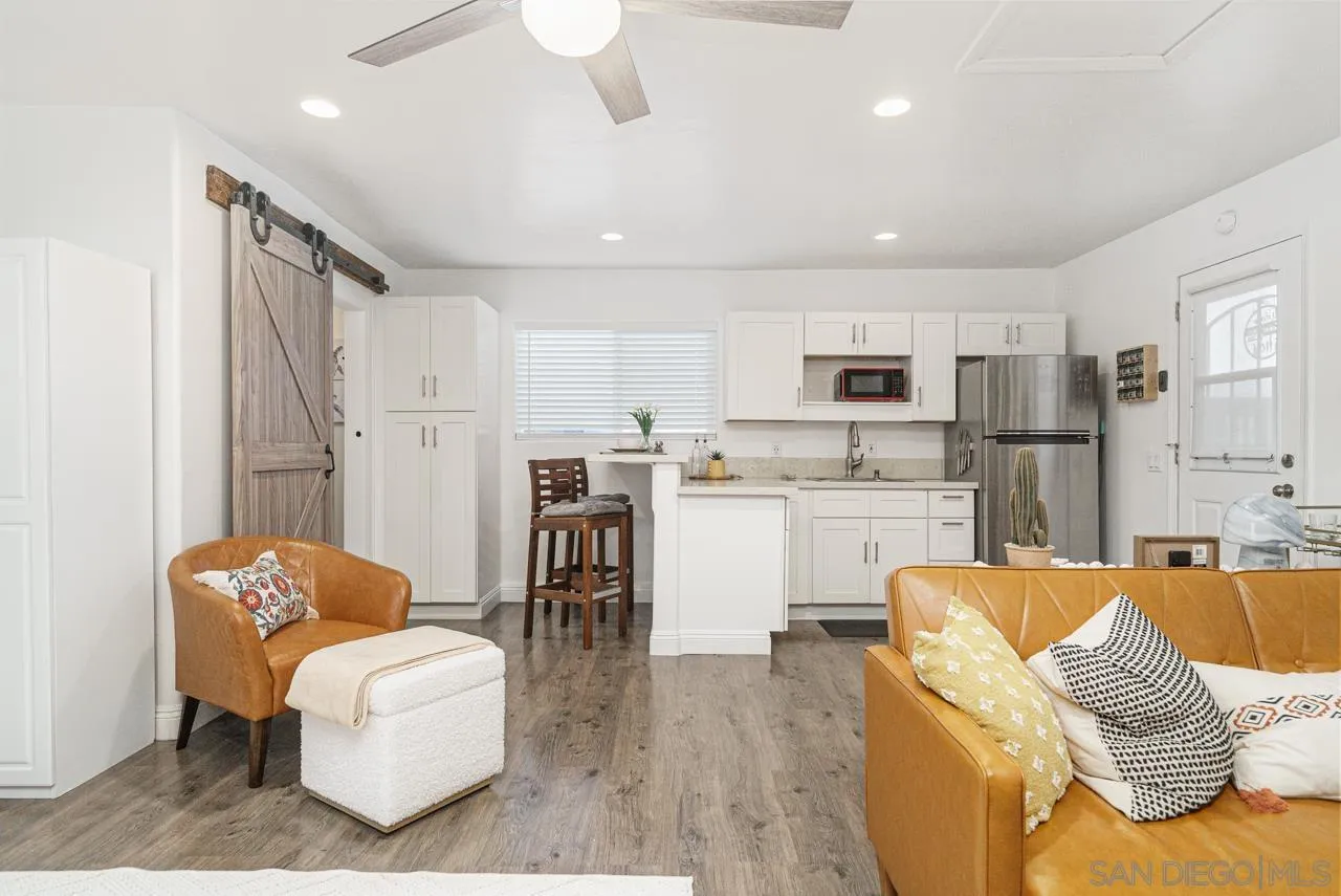 9026 Avocado Street Spring Valley, CA 91977 - Photo 17 of 27 a living room with stainless steel appliances furniture and a view of kitchen