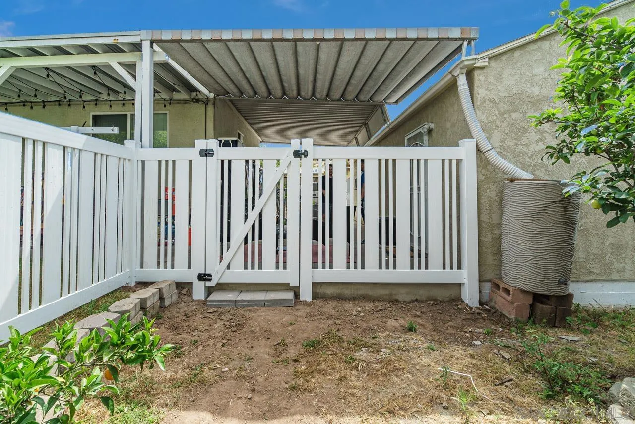 9026 Avocado Street Spring Valley, CA 91977 - Photo 25 of 27 a view of a backyard with wooden fence