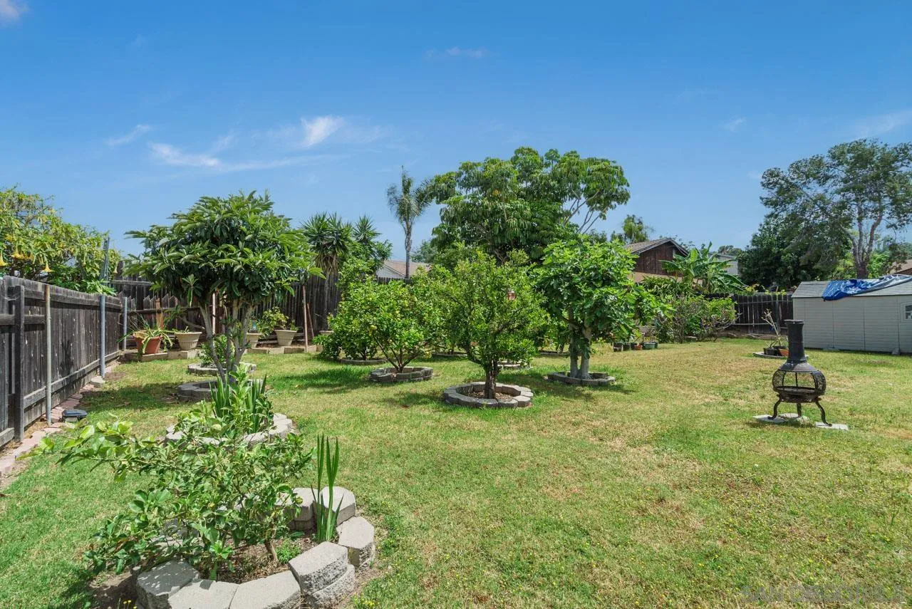 9026 Avocado Street Spring Valley, CA 91977 - Photo 26 of 27 a garden with trees in the background
