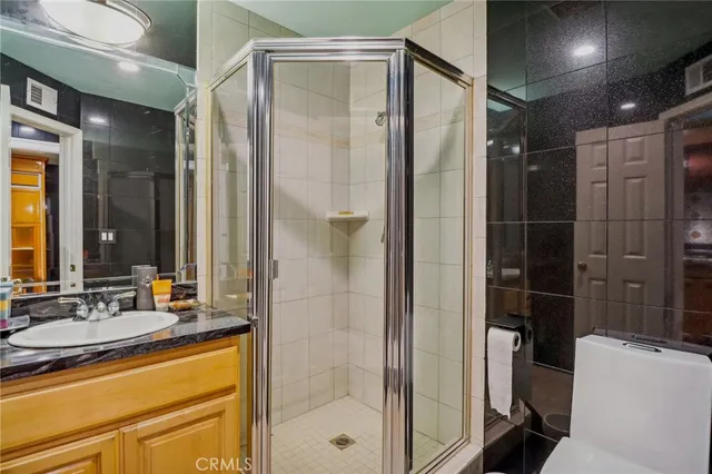 a view of an empty room with wooden floor and windows