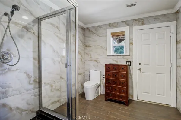 a spacious bathroom with a granite countertop sink and a mirror