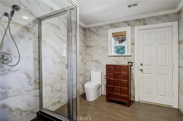 a spacious bathroom with a granite countertop sink and a mirror