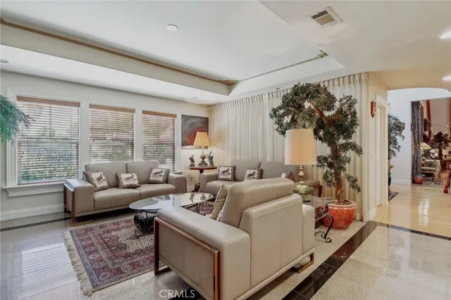 a living room with furniture fireplace and a large window