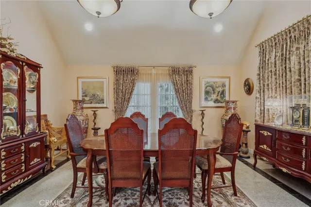 a kitchen with stainless steel appliances granite countertop table chairs sink and cabinets