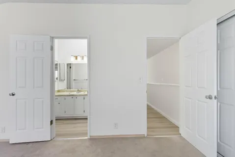 a bathroom with a granite countertop sink vanity and mirror