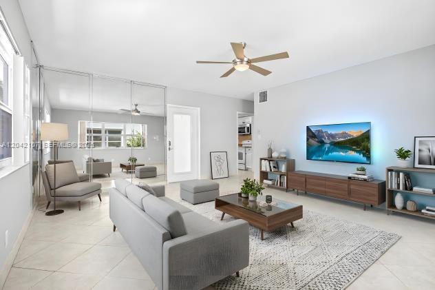 3213 Colony Club Road, Unit 3E Pompano Beach, FL 33062 - Photo 29 of 31 a living room with furniture and a large window