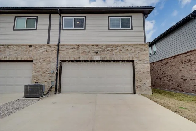 a front view of a house with garage