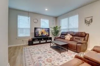 a living room with furniture and a flat screen tv