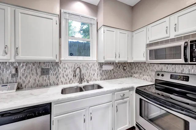 a kitchen with a sink stove and microwave