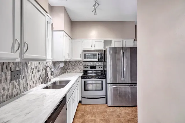 a bathroom with a sink toilet double vanity and a mirror