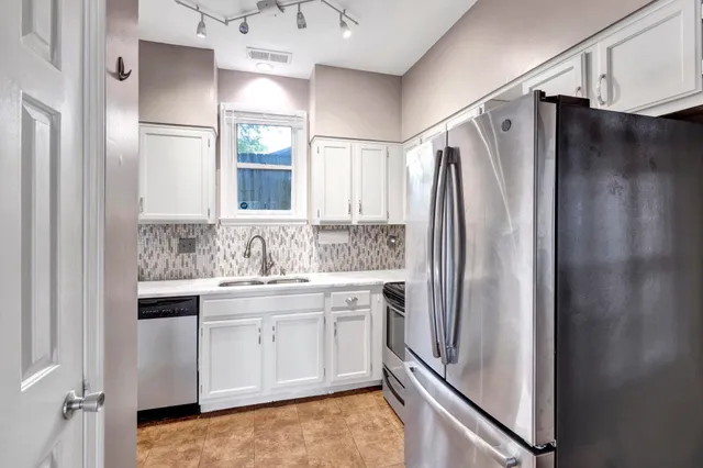 an empty room with window ceiling fan and windows