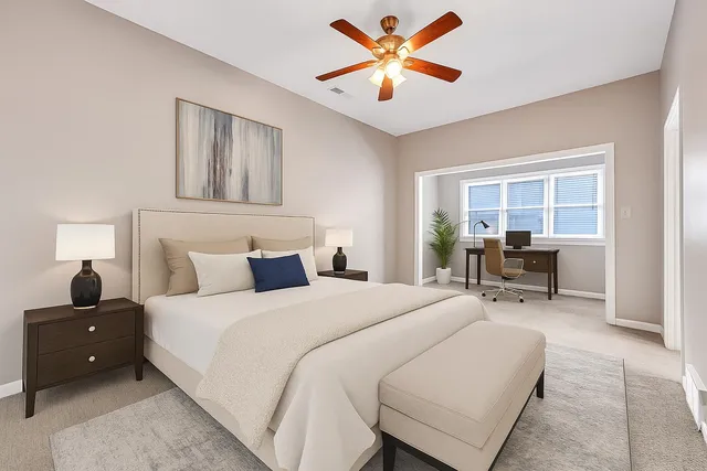 an empty room with windows and chandelier fan