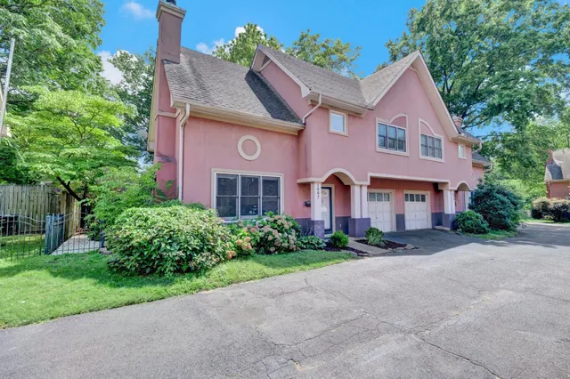 a front view of a house with a yard and a garage