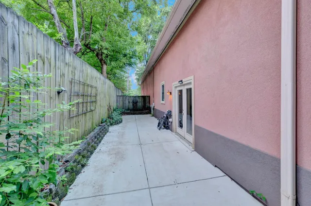 a backyard of a house with potted plants and wooden fence