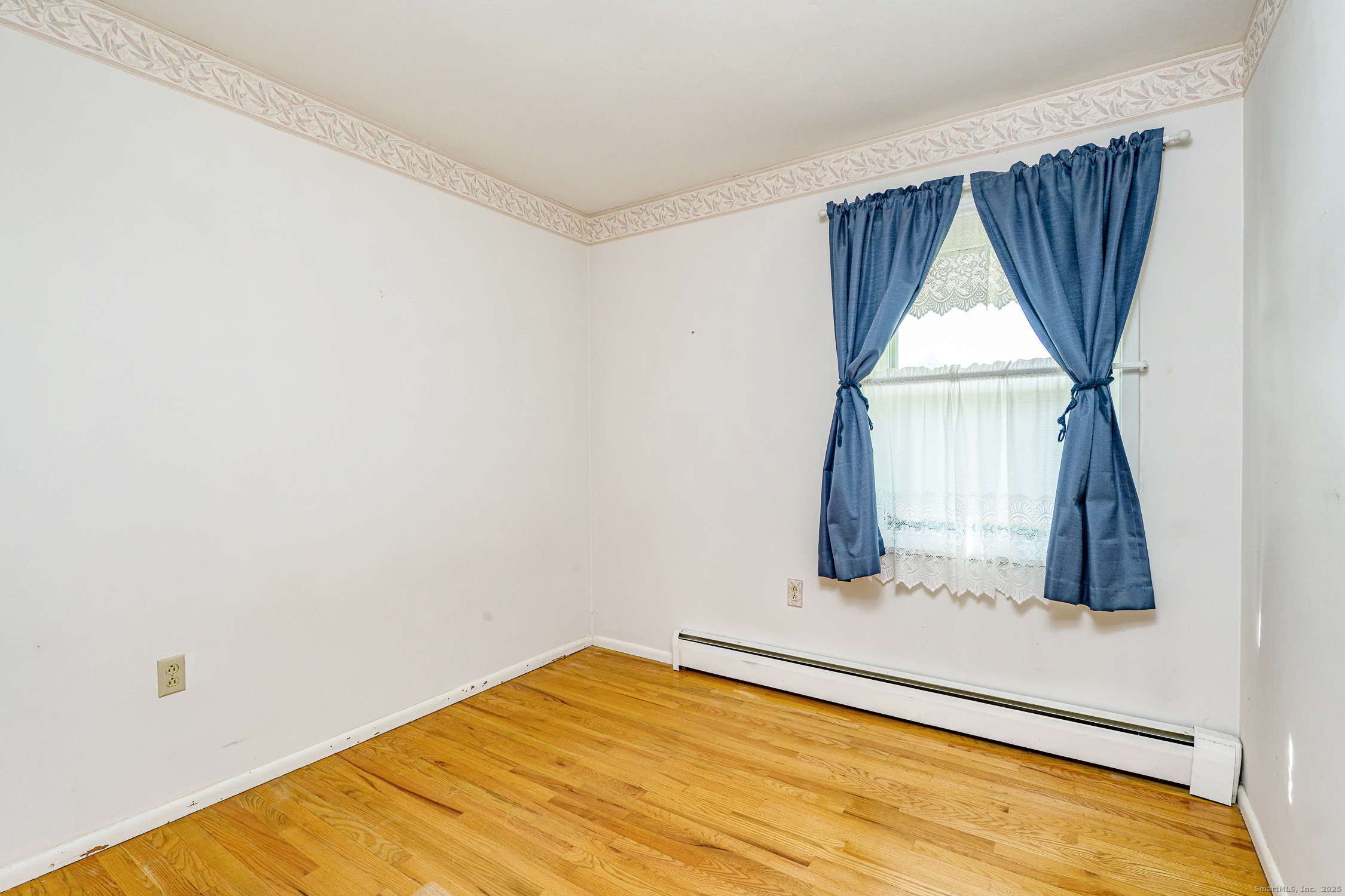 38 Toper Road Plainfield, CT 06374 - Photo 12 of 35 a view of empty room with wooden floor and fan