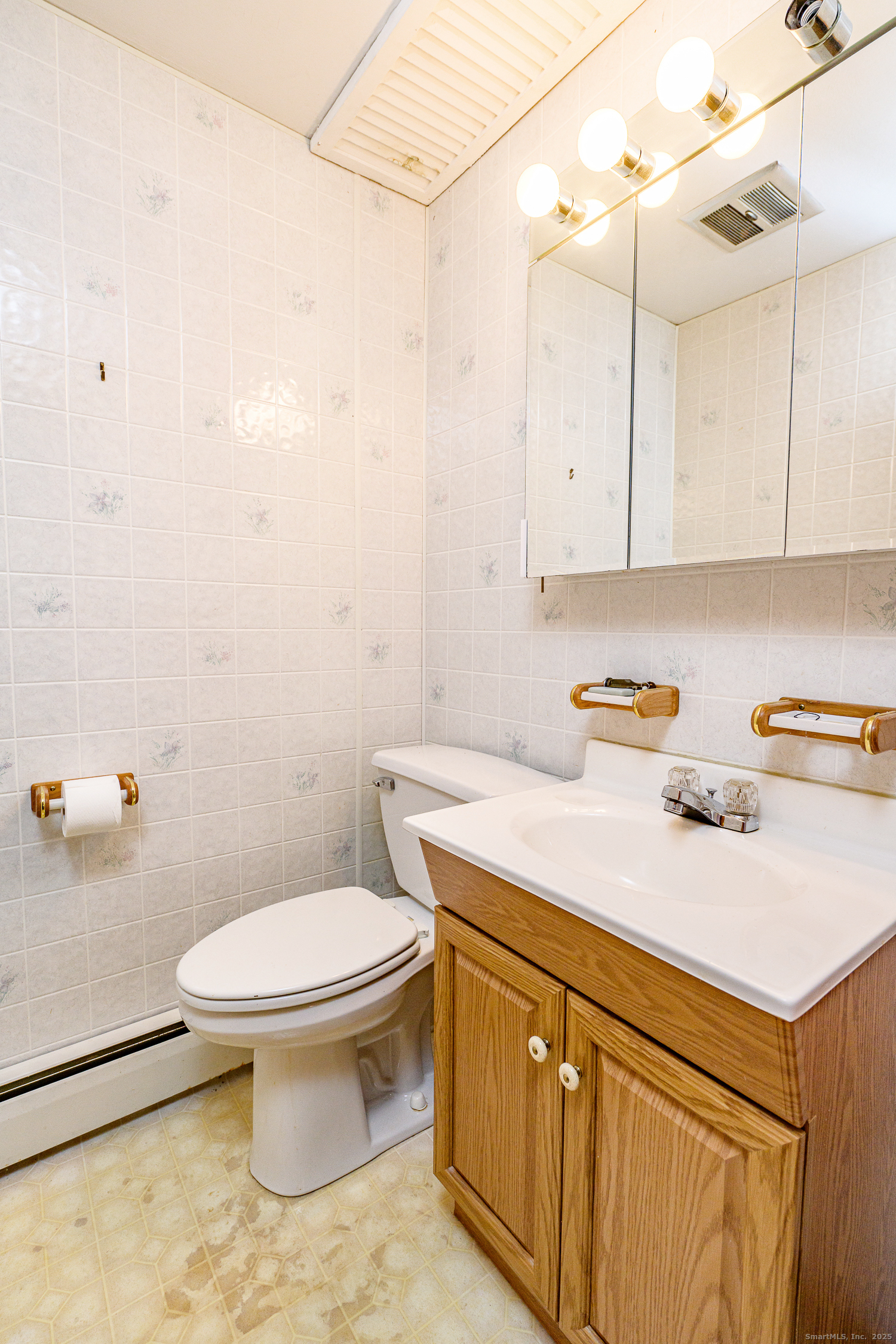 38 Toper Road Plainfield, CT 06374 - Photo 26 of 35 a bathroom with a sink toilet and vanity