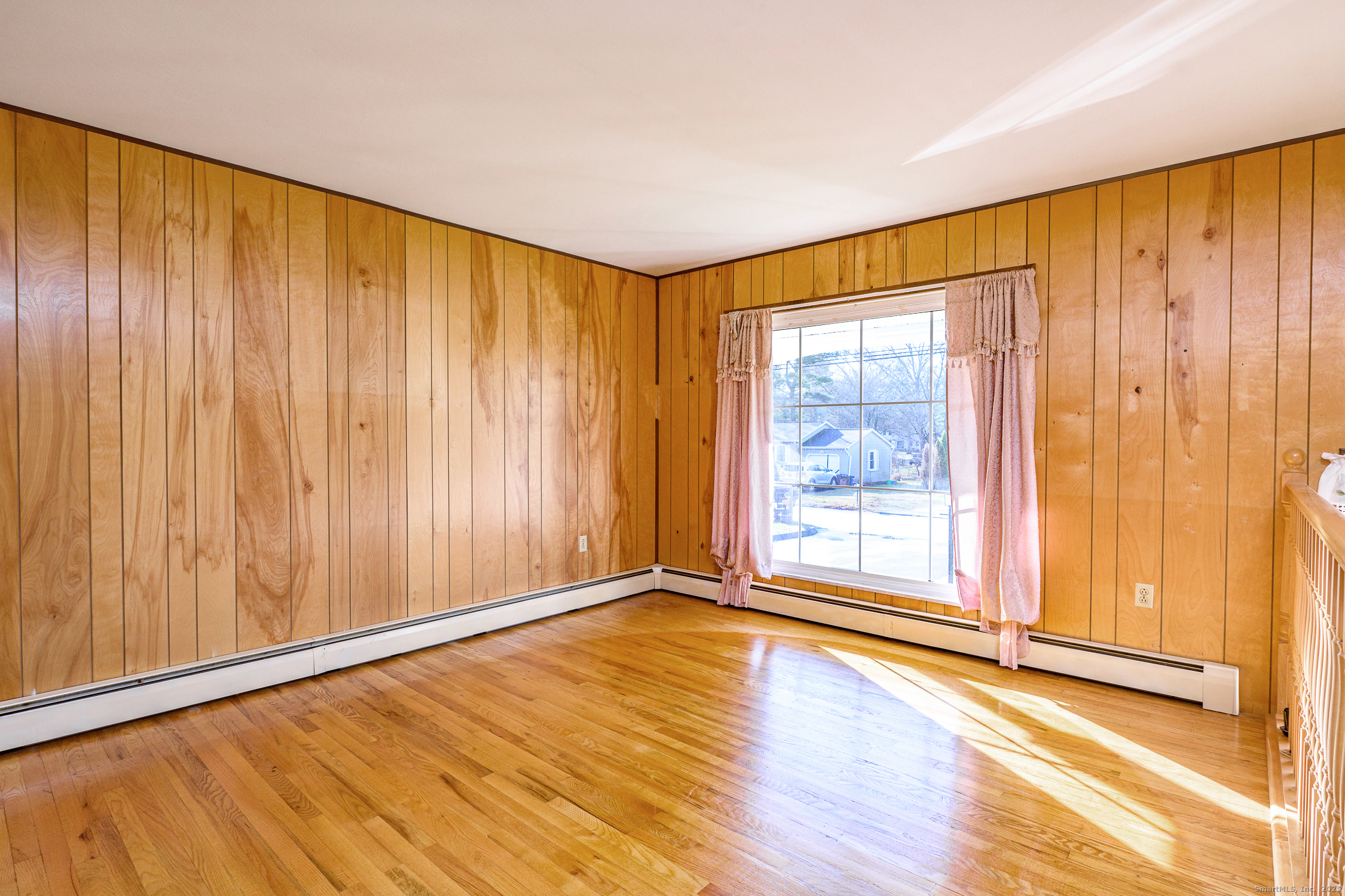 38 Toper Road Plainfield, CT 06374 - Photo 6 of 35 a view of an empty room with wooden floor and a window