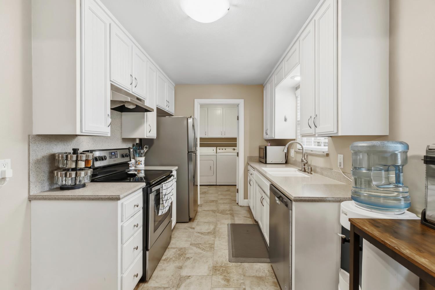 550 Bell Street Turlock, CA 95380 - Photo 11 of 36 a kitchen with stainless steel appliances granite countertop a sink stove and refrigerator