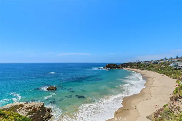 a dining room with furniture a chandelier and wooden floor